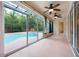 Enclosed patio featuring ceiling fans and large sliding glass doors to the gorgeous pool at 16500 Cedar Run Dr, Orlando, FL 32828