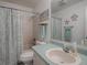 Well-lit bathroom features a shower and tub combo, and updated vanity with a light blue countertop at 1707 E Schwartz Blvd, Lady Lake, FL 32159