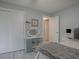 This bedroom includes a lit vanity, sizable closet, and soothing gray walls at 1707 E Schwartz Blvd, Lady Lake, FL 32159