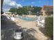 Community pool surrounded by seating, tables, and trees for a relaxing outdoor experience at 1707 E Schwartz Blvd, Lady Lake, FL 32159