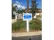 Welcome sign to the Hilltop Adult Pool with hours and age requirements in a landscaped area at 1707 E Schwartz Blvd, Lady Lake, FL 32159