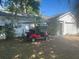 Charming single-story home with a well-maintained front yard and a red golf cart out front at 1707 E Schwartz Blvd, Lady Lake, FL 32159