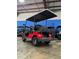Back view of a new red Advanced EV golf cart with black seats and a roof at 1707 E Schwartz Blvd, Lady Lake, FL 32159