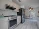 Updated kitchen with stainless steel appliances, overlooking the dining area at 1707 E Schwartz Blvd, Lady Lake, FL 32159