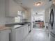 Modern kitchen with white cabinets and view into the dining area and office space at 1707 E Schwartz Blvd, Lady Lake, FL 32159