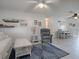 Open-concept living area with ceiling fan, gray armchair, and dining area in view at 1707 E Schwartz Blvd, Lady Lake, FL 32159