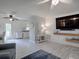 Open-concept living area with wood-look floors and stylish décor leading to kitchen at 1707 E Schwartz Blvd, Lady Lake, FL 32159