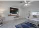 Bright living room featuring wood floors, a flat screen TV, modern decor, and a comfortable couch at 1707 E Schwartz Blvd, Lady Lake, FL 32159
