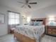 Comfortable main bedroom featuring a ceiling fan, and a wicker frame bed at 1707 E Schwartz Blvd, Lady Lake, FL 32159