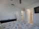 Bedroom featuring a view of the ensuite bathroom at 1707 E Schwartz Blvd, Lady Lake, FL 32159