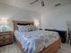 Well-lit bedroom with a wicker bed, coastal accents, and wooden nightstands at 1707 E Schwartz Blvd, Lady Lake, FL 32159