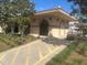 Community pool house with decorative archways, lighting, and landscaping for an inviting atmosphere at 1707 E Schwartz Blvd, Lady Lake, FL 32159
