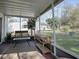Large screened-in porch with furniture and backyard views, ideal for relaxation and entertaining at 1707 E Schwartz Blvd, Lady Lake, FL 32159