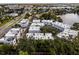 Aerial view showcases a vibrant community of modern townhomes near a scenic lake at 1764 Mondrian Cir, Winter Park, FL 32789