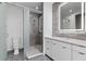 Modern bathroom with glass shower, marble-look walls, a sleek vanity, and unique hexagonal tile floor at 1764 Mondrian Cir, Winter Park, FL 32789