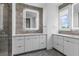Modern bathroom featuring a glass shower, lighted mirror and dual vanity with a beautiful accent wall at 1764 Mondrian Cir, Winter Park, FL 32789