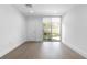 Bright bedroom featuring hardwood floors and a sliding glass door to a patio at 1764 Mondrian Cir, Winter Park, FL 32789