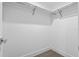 Walk-in closet featuring two metal rails for hanging cloths and hardwood floors at 1764 Mondrian Cir, Winter Park, FL 32789