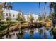 Modern condo exterior with clean lines reflecting in a serene water feature and verdant landscaping at 1764 Mondrian Cir, Winter Park, FL 32789