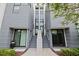 Modern townhome with a gray exterior and a stairway leading to a central entrance at 1764 Mondrian Cir, Winter Park, FL 32789