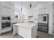 Modern kitchen featuring sleek white cabinetry, stainless steel appliances, and an island at 1764 Mondrian Cir, Winter Park, FL 32789