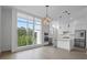 Modern, all-white kitchen featuring stainless steel appliances, marble countertops, and a large window for natural light at 1764 Mondrian Cir, Winter Park, FL 32789