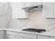 Modern kitchen features sleek white cabinets, quartz countertops, and stainless steel gas range at 1764 Mondrian Cir, Winter Park, FL 32789