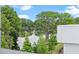 A stunning lake view is visible from the property, surrounded by lush green trees at 1764 Mondrian Cir, Winter Park, FL 32789