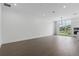 Bright, open-concept living space with hardwood floors and large windows at 1764 Mondrian Cir, Winter Park, FL 32789