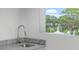 Outdoor kitchen includes a granite countertop, stainless steel sink with a picturesque lake view at 1764 Mondrian Cir, Winter Park, FL 32789