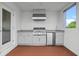 Outdoor kitchen with stainless steel grill, granite countertops and wood-look flooring at 1764 Mondrian Cir, Winter Park, FL 32789