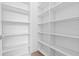 Bright pantry featuring floor-to-ceiling white shelving for optimal storage and organization at 1764 Mondrian Cir, Winter Park, FL 32789