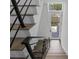 Modern staircase with black metal railings leads to the front door, providing a bright entryway at 1764 Mondrian Cir, Winter Park, FL 32789