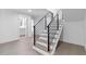 Open staircase with light wood treads and contemporary metal railing leading to upper levels of the home at 1764 Mondrian Cir, Winter Park, FL 32789