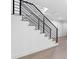 Staircase featuring modern black railings and hardwood steps at 1764 Mondrian Cir, Winter Park, FL 32789