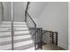 Contemporary staircase with black metal railing, light wood treads, and white risers at 1764 Mondrian Cir, Winter Park, FL 32789