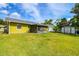 Spacious back yard with green grass, shed, and screened patio at 206 Montana Ave, St Cloud, FL 34769