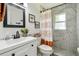 Clean bathroom with a marble-tiled walk-in shower, modern sink, and decorative accents at 206 Montana Ave, St Cloud, FL 34769