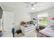 Well-lit bedroom features two beds, light wood floors, and plenty of space at 206 Montana Ave, St Cloud, FL 34769