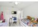 Bright bedroom with twin beds, light wood floors, and a tidy study area at 206 Montana Ave, St Cloud, FL 34769