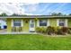 Close up view of a well-maintained home showing shutters, landscaping, and a tidy front lawn at 206 Montana Ave, St Cloud, FL 34769