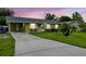 Charming single-story home with a long driveway, mature landscaping, and inviting curb appeal at 206 Montana Ave, St Cloud, FL 34769