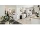 Kitchen and dining area with light wood-look floors and white cabinetry for a clean, modern look at 206 Montana Ave, St Cloud, FL 34769