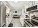 Clean kitchen with stainless steel appliances open to the dining area; perfect for modern living at 206 Montana Ave, St Cloud, FL 34769