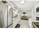 Bright and modern kitchen with stainless steel appliances and an open layout to the dining area at 206 Montana Ave, St Cloud, FL 34769
