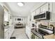 Open kitchen flowing into the dining area, featuring modern appliances and a sleek design at 206 Montana Ave, St Cloud, FL 34769