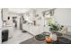 Bright kitchen featuring white cabinets, stainless steel appliances, and dining area, perfect for Gathering meals at 206 Montana Ave, St Cloud, FL 34769