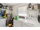 Functional laundry area with washer, dryer, and storage shelves for all cleaning needs at 206 Montana Ave, St Cloud, FL 34769