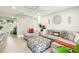 Bright living room features an accent wall, tile floors, modern furnishings, and plenty of natural light at 206 Montana Ave, St Cloud, FL 34769
