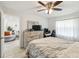 Bright main bedroom with wood-look flooring, ceiling fan and adjacent sitting room at 206 Montana Ave, St Cloud, FL 34769